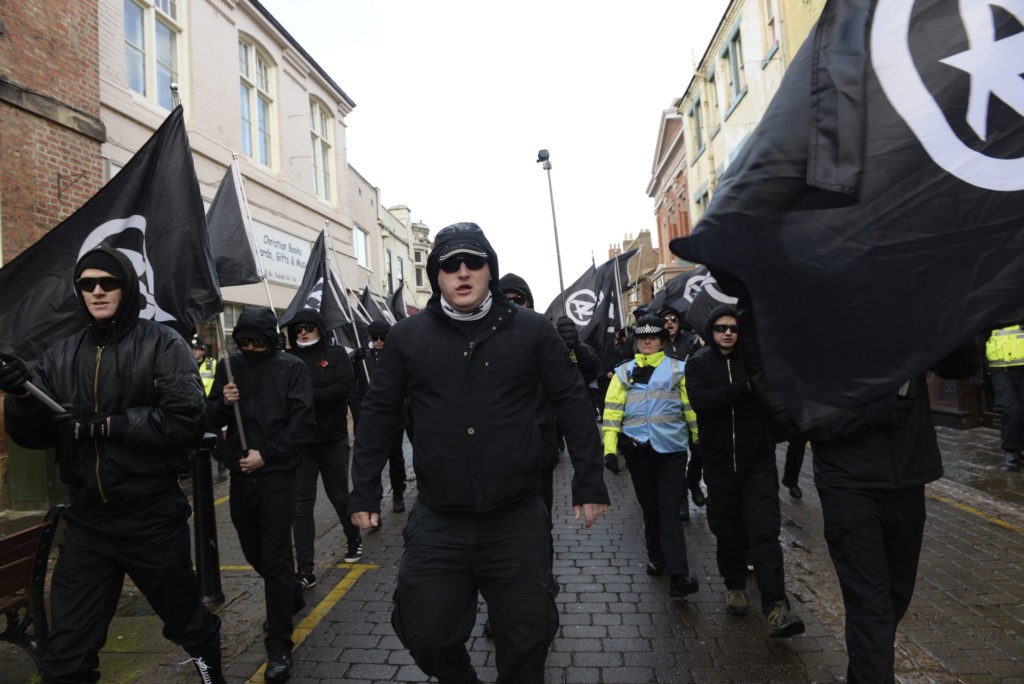 neo-nazi group National Action marching, looking menacing