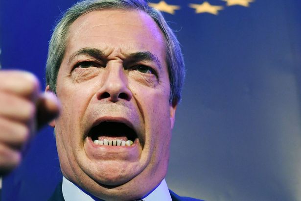 Brexit Party leader Nigel Farage looking angry whilst giving a speech