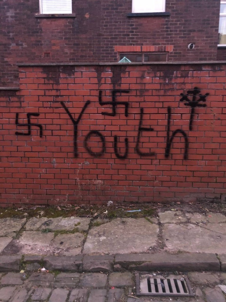 3 swastika's have been graffitied onto a wall. The word 'youth' written below the nazi symbol

