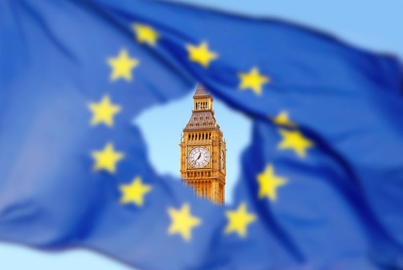 A hole in the EU flag with Big Ben appearing visibly in the background